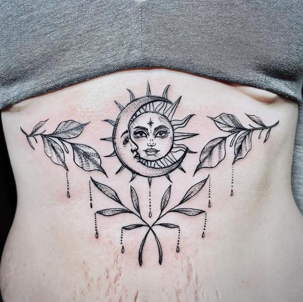 Sun and moon with leaves stomach tattoo