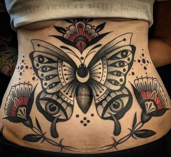 Traditional butterfly with eyes stomach tattoo