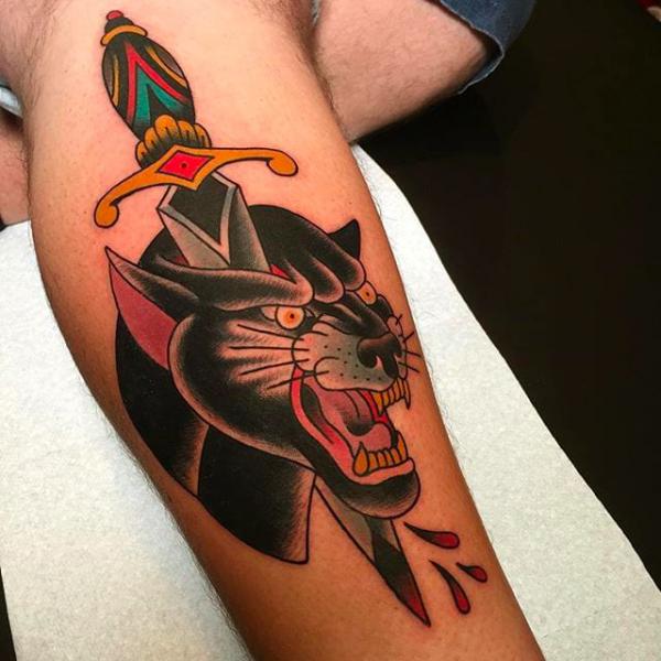 Traditional dagger panther tattoo on lower leg