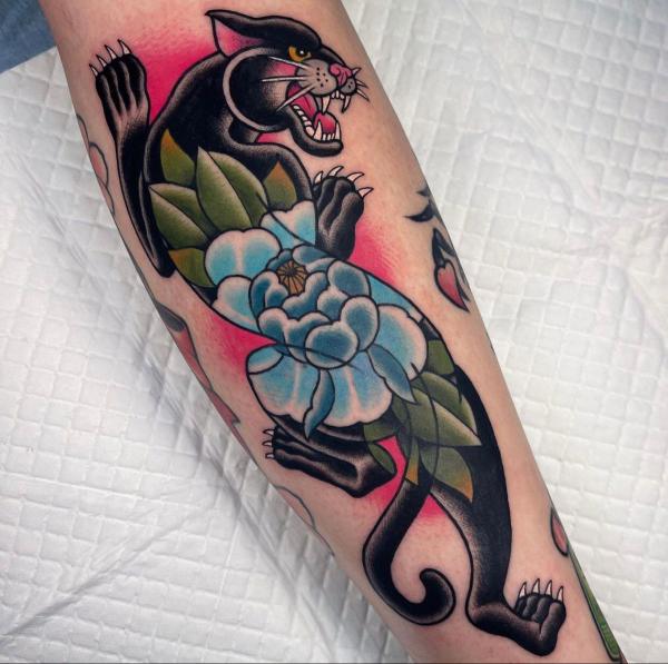 Traditional panther with blue peony tattoo