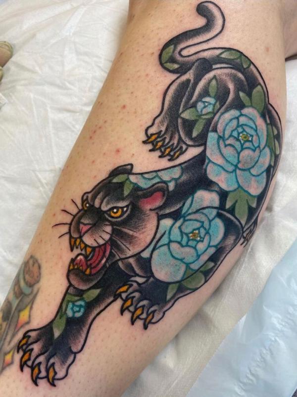 Traditional panther with blue rose leg tattoo