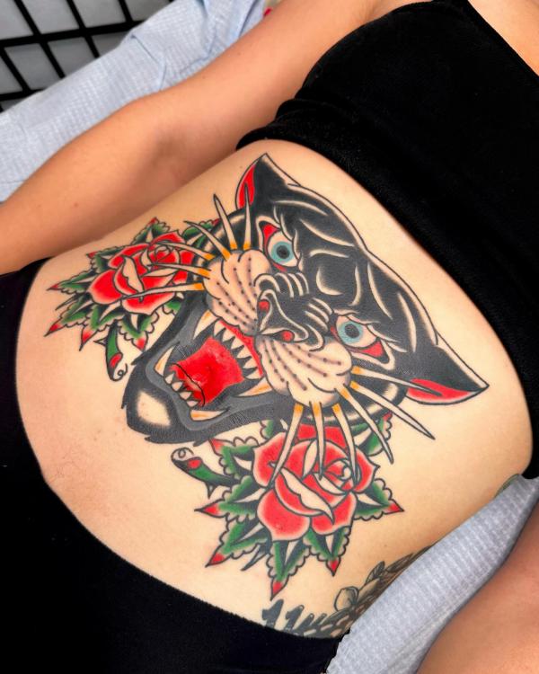 Traditional panther with roses stomach tattoo