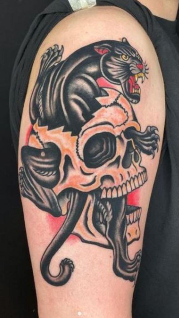 Traditional panther with skull tattoo