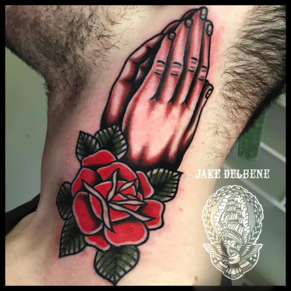Traditional praying hands with rose tattoo on neck