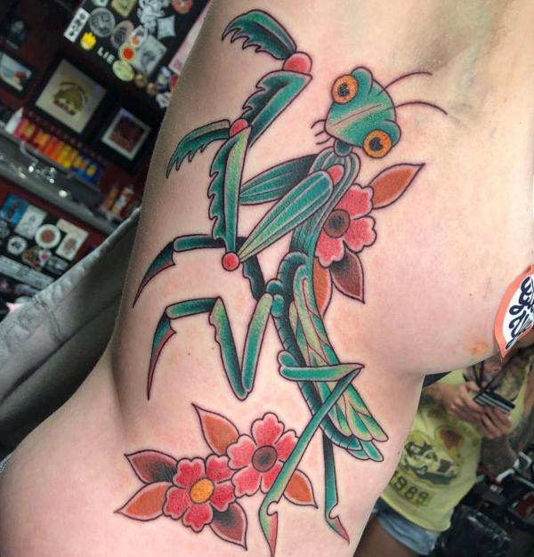 Traditional praying mantis and flower side tattoo