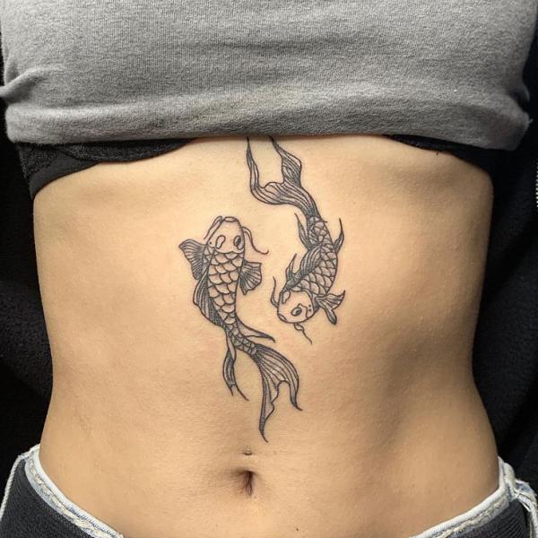 Two koi fish swimming in the opposite direction stomach tattoo