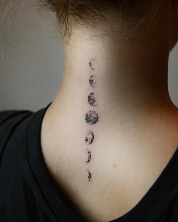 Vertical moon phases tattoo on back of neck