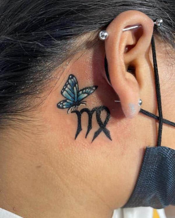 Virgo and blue butterfly tattoo behind ear