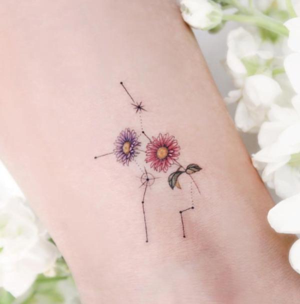 Virgo constellation with daisy flower tattoo