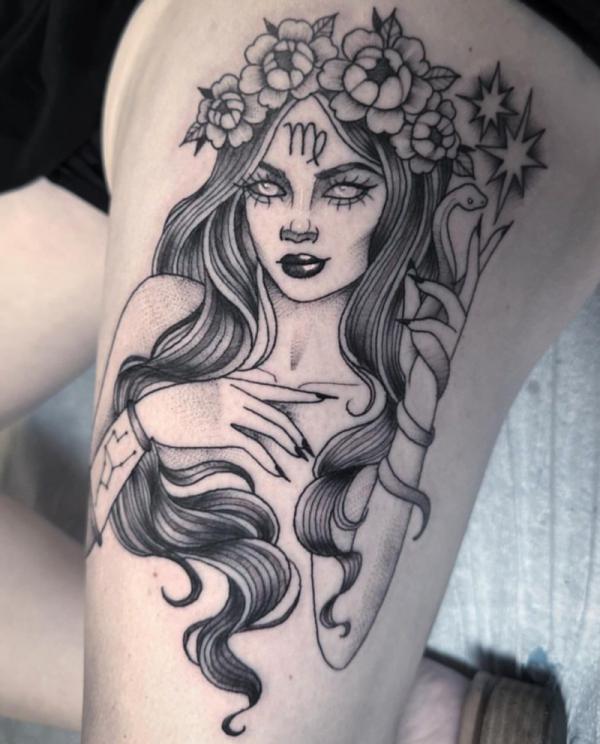 Virgo woman with snake and flowers thigh tattoo