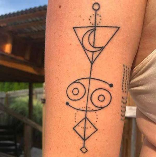 Water moon and cancer glyph tattoo arm