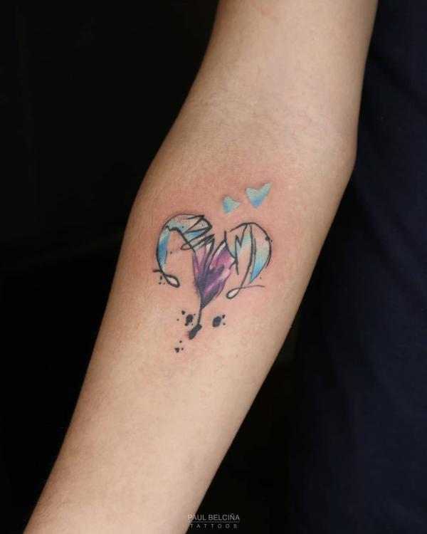 Watercolor Aries with heart tattoo below inner elbow