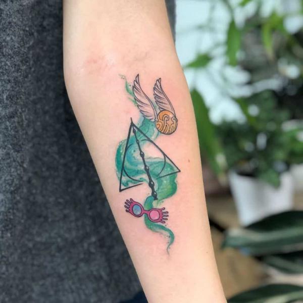 Watercolor Golden Snitch glasses and deathly hallows forearm tattoo
