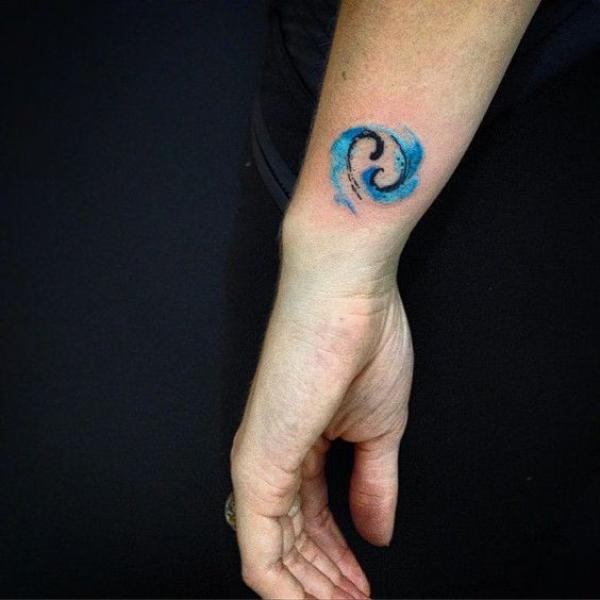 Watercolor cancer glyph wrist tattoo