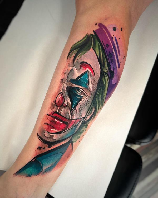 Watercolor half Joker face tattoo