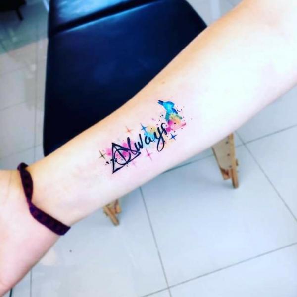 Watercolor harry potter deathly hallows with name tattoo on inner forearm
