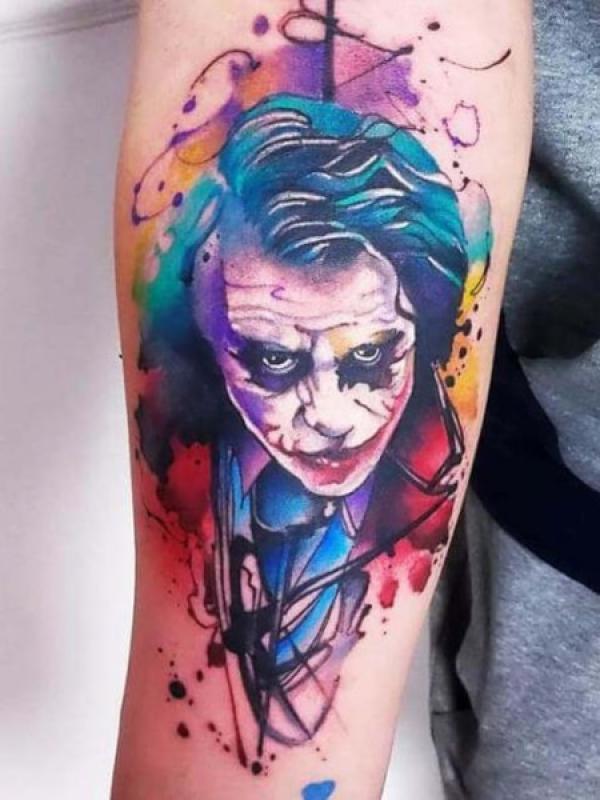 Watercolor joker inner forearm tattoo