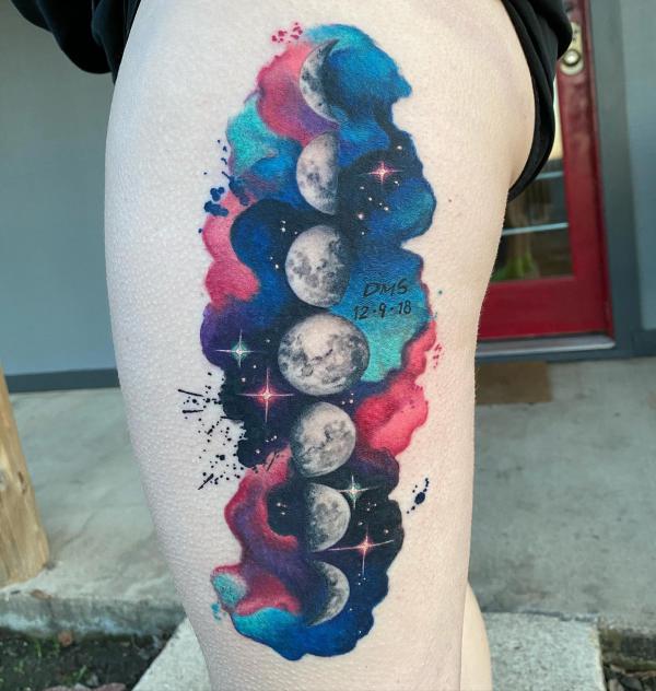 Watercolor moon phases with stars thigh tattoo