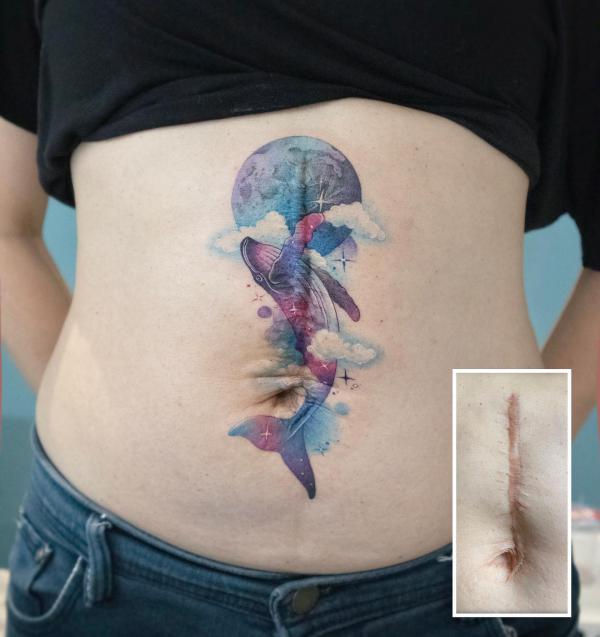 Watercolor whale stomach tattoo