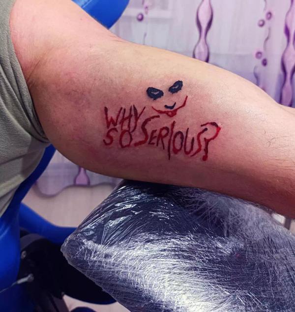 Why so serious Joker eyes and mouth tattoo