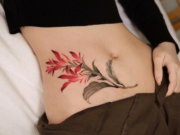 Wild flower side stomach tattoo