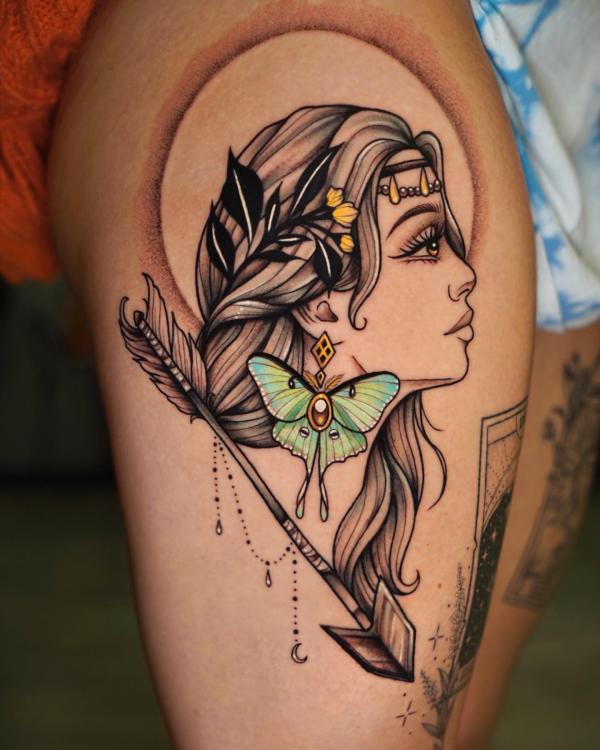 Woman with luna moth and arrow tattoo