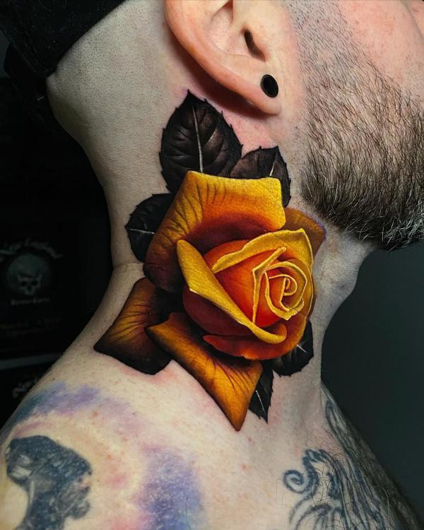 Yellow rose tattoo on the side of neck