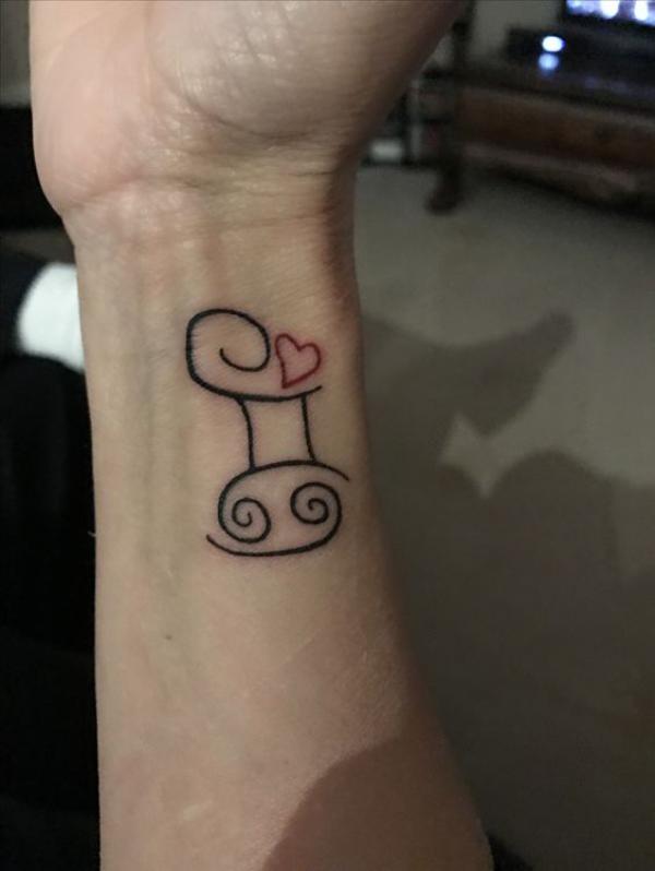 Zodiac cancer and Gemini glyph with heart tattoo