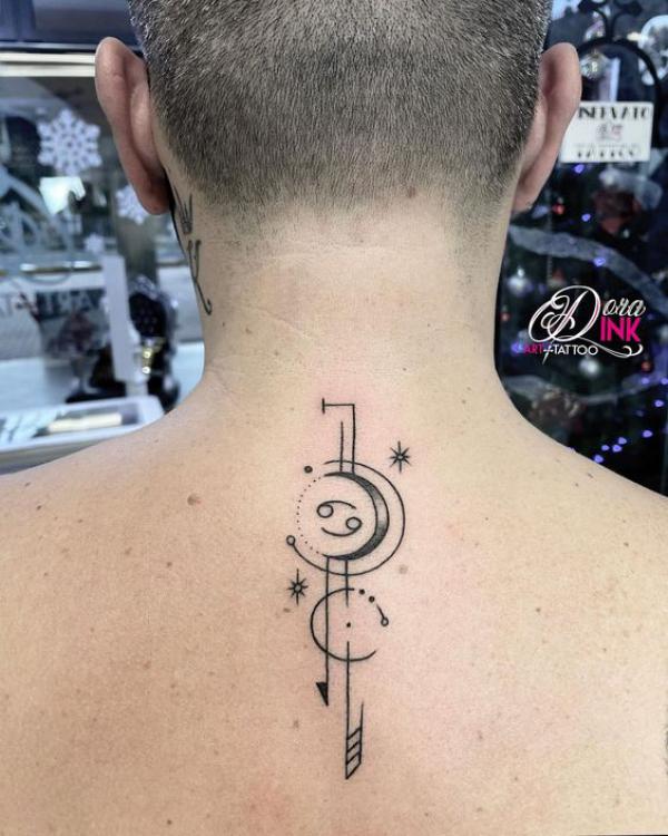 Zodiac cancer and moon glyph upper back tattoo