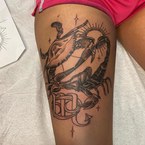 Zodiac cancer crab and scorpio with sun tattoo on thigh