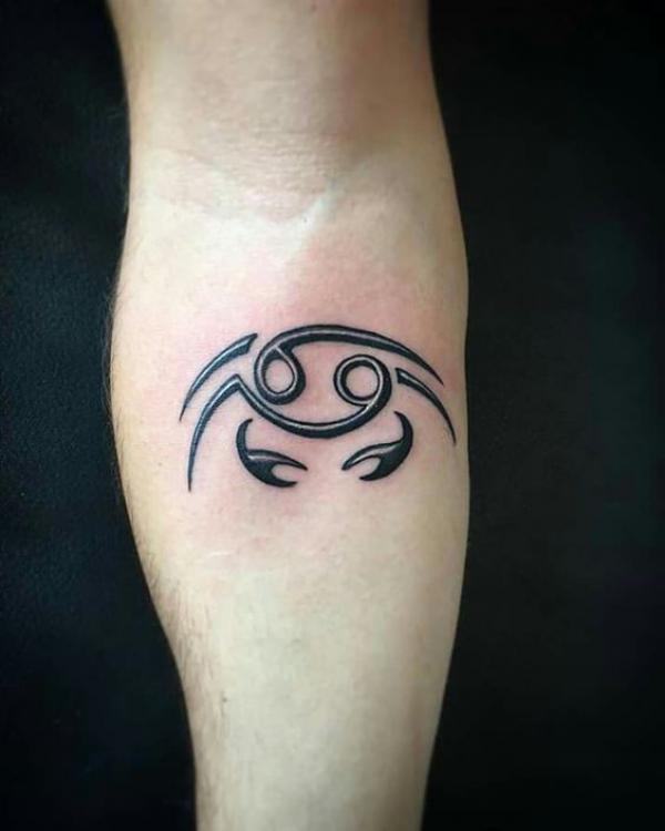 Zodiac cancer with glyph tattoo below inner elbow