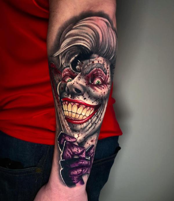 Zombie joker with a knife tattoo sleeve