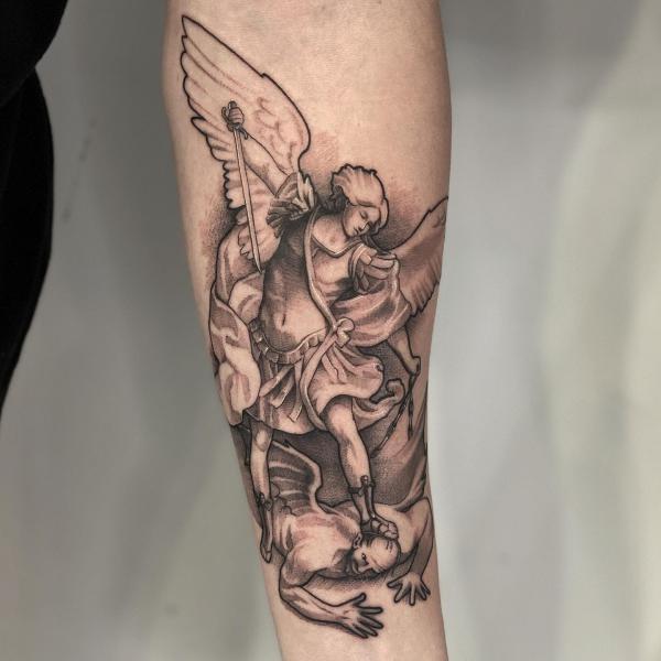 archangel michael fighting lucifer tattoo on inner forearm