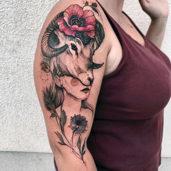 aries girl with flowers and ram headdress tattoo