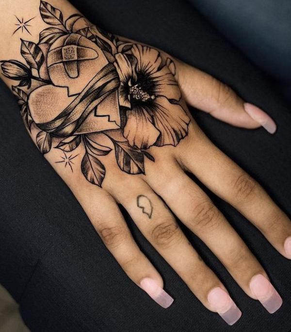 broken heart with bandaid and flower tattoo
