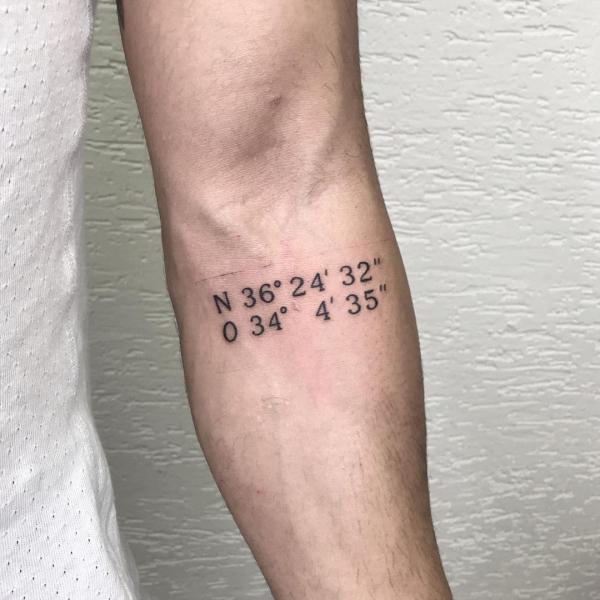 coordinates tattoo below inner elbow