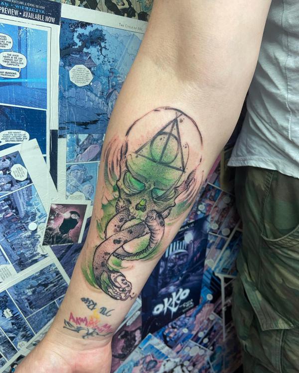 death eater and deathly hallow tattoo with green hue