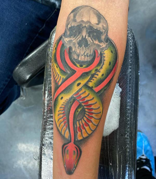 death eater with colored snake forearm tattoo