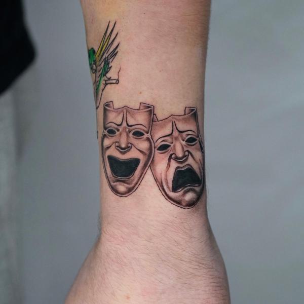 laugh now cry later masks wrist tattoo