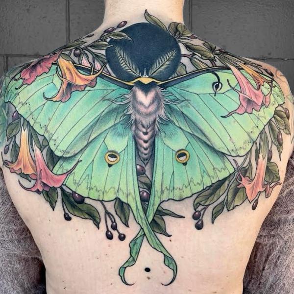 luna moth and copihue flower with moon back tattoo