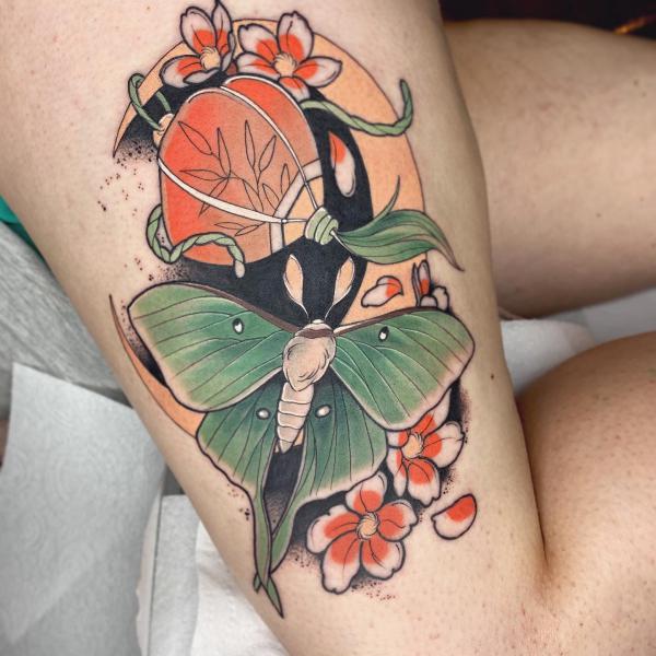 luna moth and crescent moon with flowers thigh tattoo