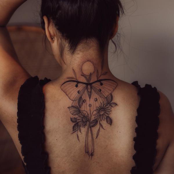 luna moth and daisy flower tattoo