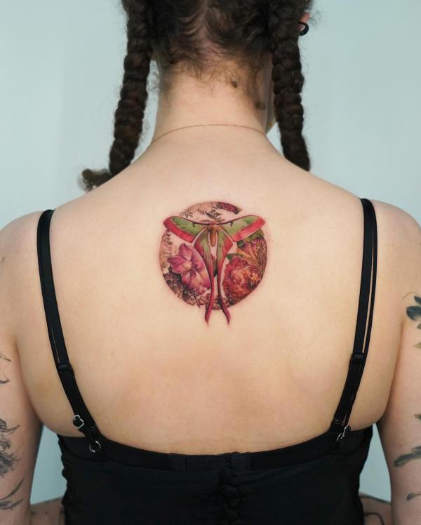 luna moth and flower circular tattoo on upper back
