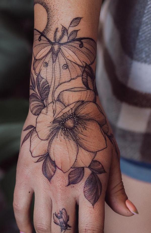 luna moth and flower wrist to hand tattoo