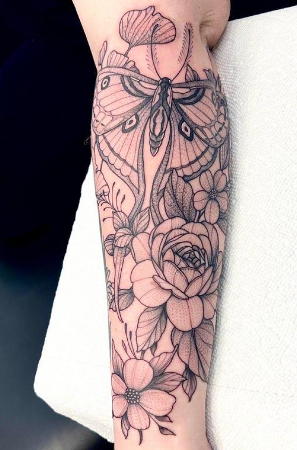 luna moth and flowers tattoo on forearm