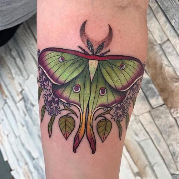 luna moth and flowers with crescent moon tattoo on inner forearm
