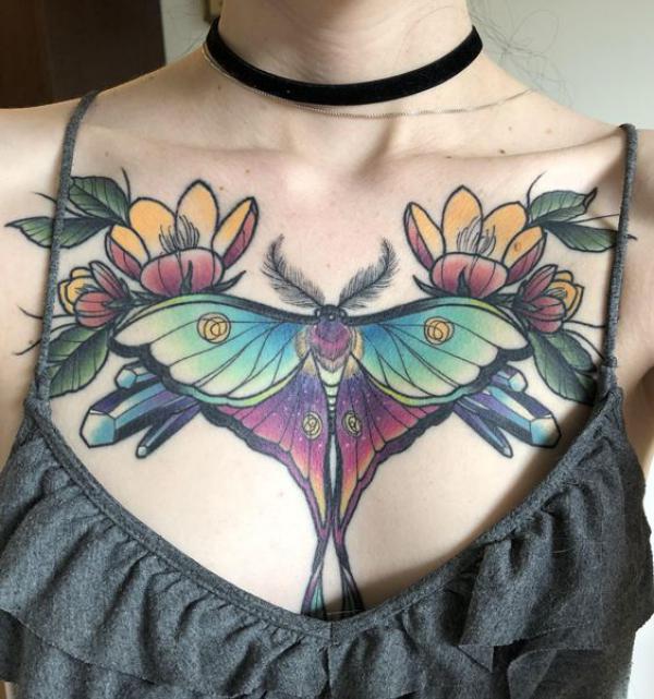 luna moth with flowers tattoo on chest
