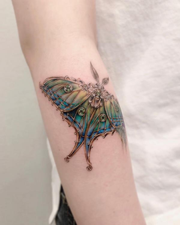 luna moth with jewelry tattoo
