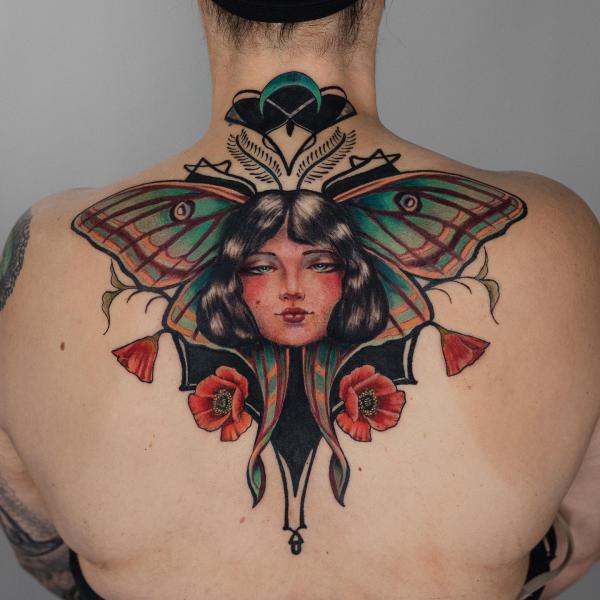 luna moth woman with flower back tattoo