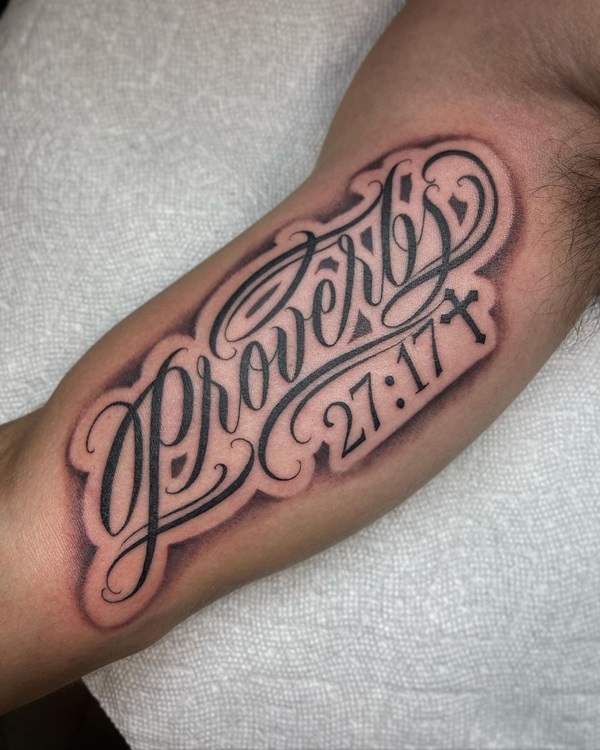 proverbs 27 17 lettering bicep tattoo